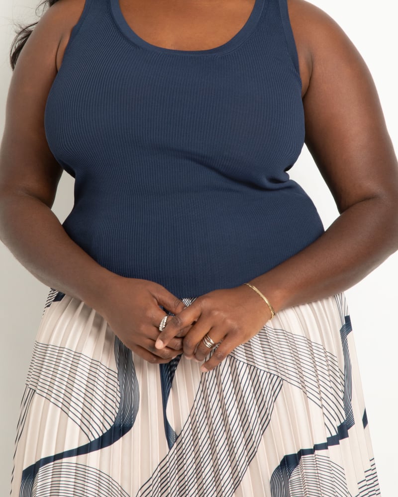 Side of a model wearing a size 18|20 Scoop Neck Knitted Tank in Dress Blues by ELOQUII. | dia_product_style_image_id:294995